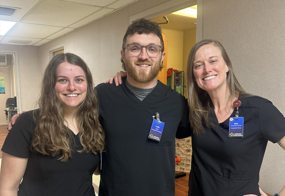 Three Pershing Health System Occupational Therapy team members standing together in the rehabilitation department.